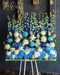 Grand luxury blue and white flower arrangement with hydrangeas, white roses and tall delphinium blooms by The One Flowers UAE