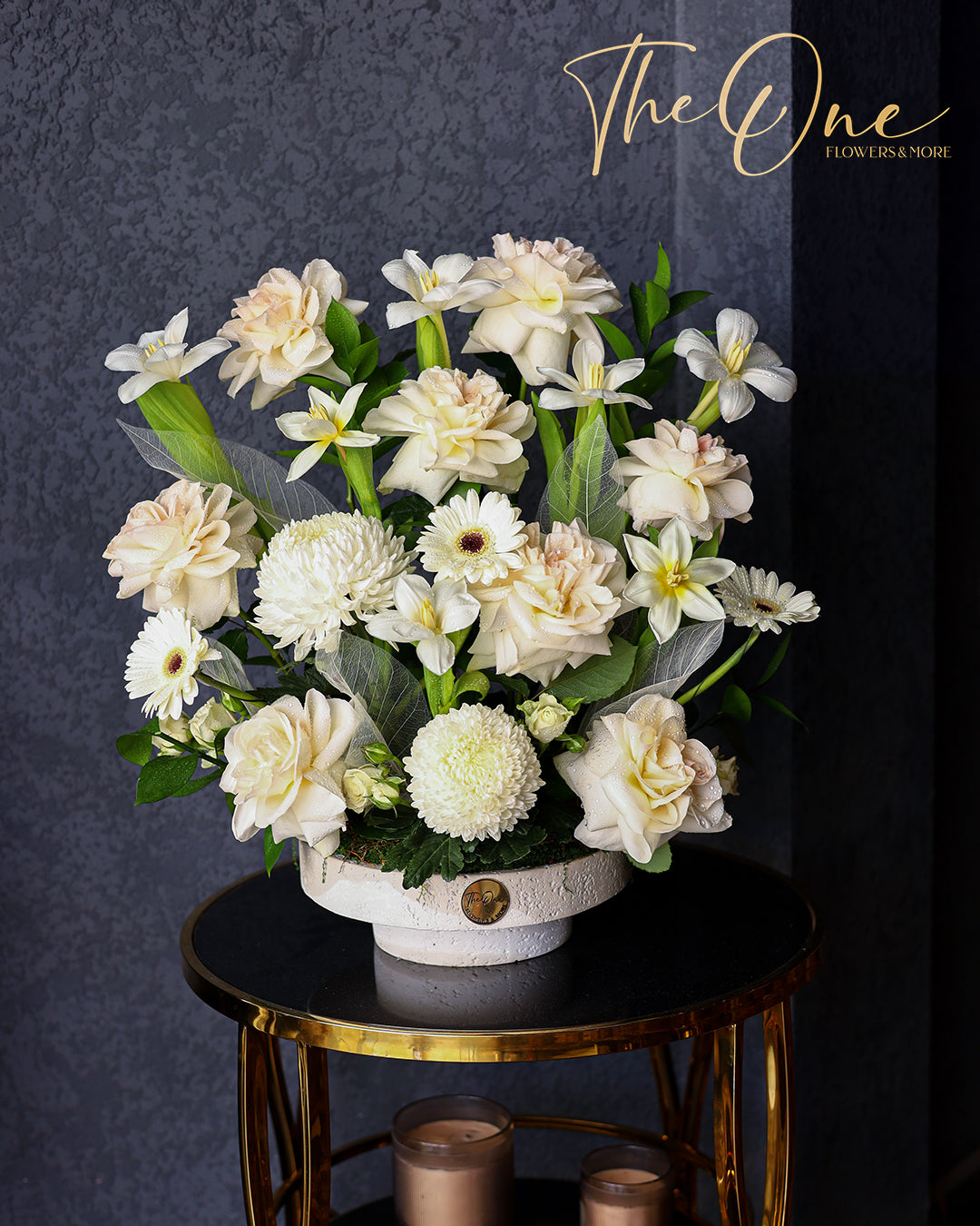 Luxury ivory and white flower arrangement with roses, chrysanthemums and gerbera daisies in a white vase by The One Flowers Al Ain