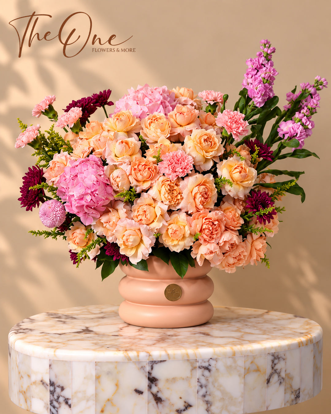 Luxury peach and pink flower arrangement with roses, hydrangeas, carnations and stock flowers in a blush vase by The One Flowers Al Ain UAE