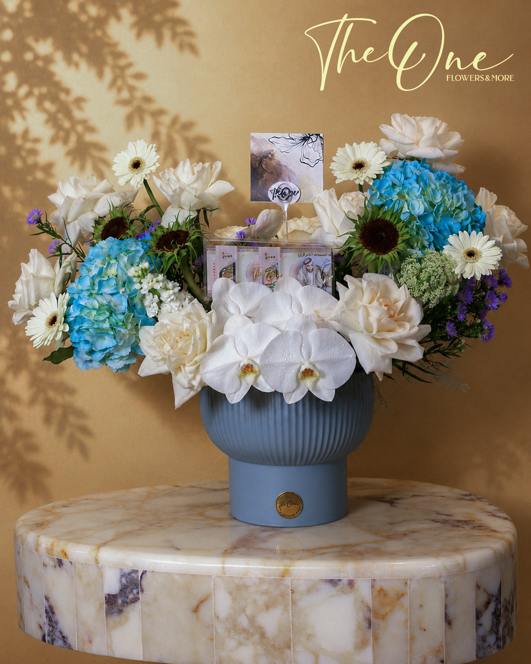 Luxury blue and white flower arrangement with blue hydrangeas, white roses and orchids by The One Flowers with delivery across UAE
