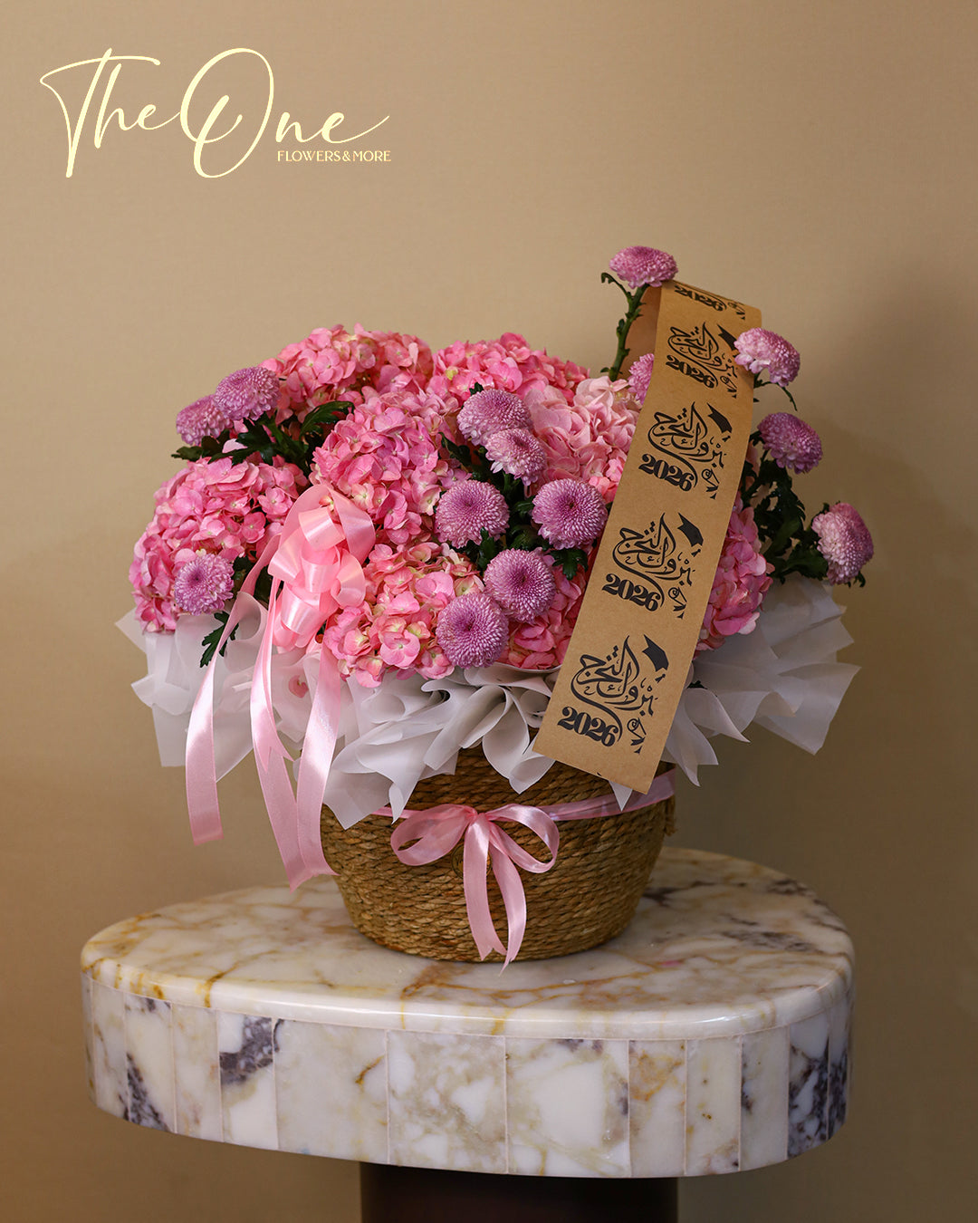 Pink graduation flower basket with hydrangeas and chrysanthemums by The One Flowers with delivery across UAE