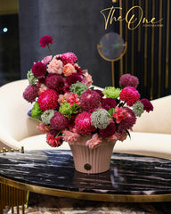 Luxury burgundy and pink flower arrangement with chrysanthemums and roses in a blush vase by The One Flowers UAE