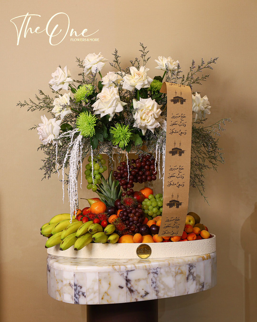 Luxury Hajj flower and fruit arrangement by The One Flowers featuring fresh flowers and seasonal fruits