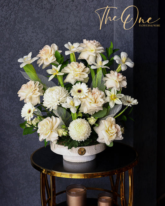 Luxury ivory and white flower arrangement with roses, chrysanthemums and gerbera daisies in a white vase by The One Flowers Al Ain
