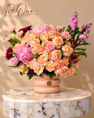 Luxury peach and pink flower arrangement with roses, hydrangeas, carnations and stock flowers in a blush vase by The One Flowers Al Ain UAE