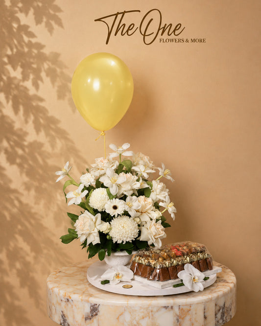 Luxury ivory and white flower arrangement with premium chocolates and balloon by The One Flowers with delivery across UAE