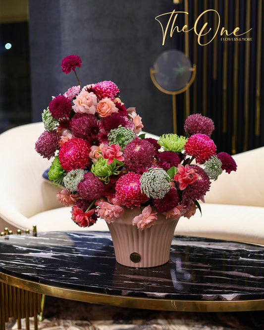 Luxury burgundy and pink flower arrangement with chrysanthemums and roses in a blush vase by The One Flowers UAE